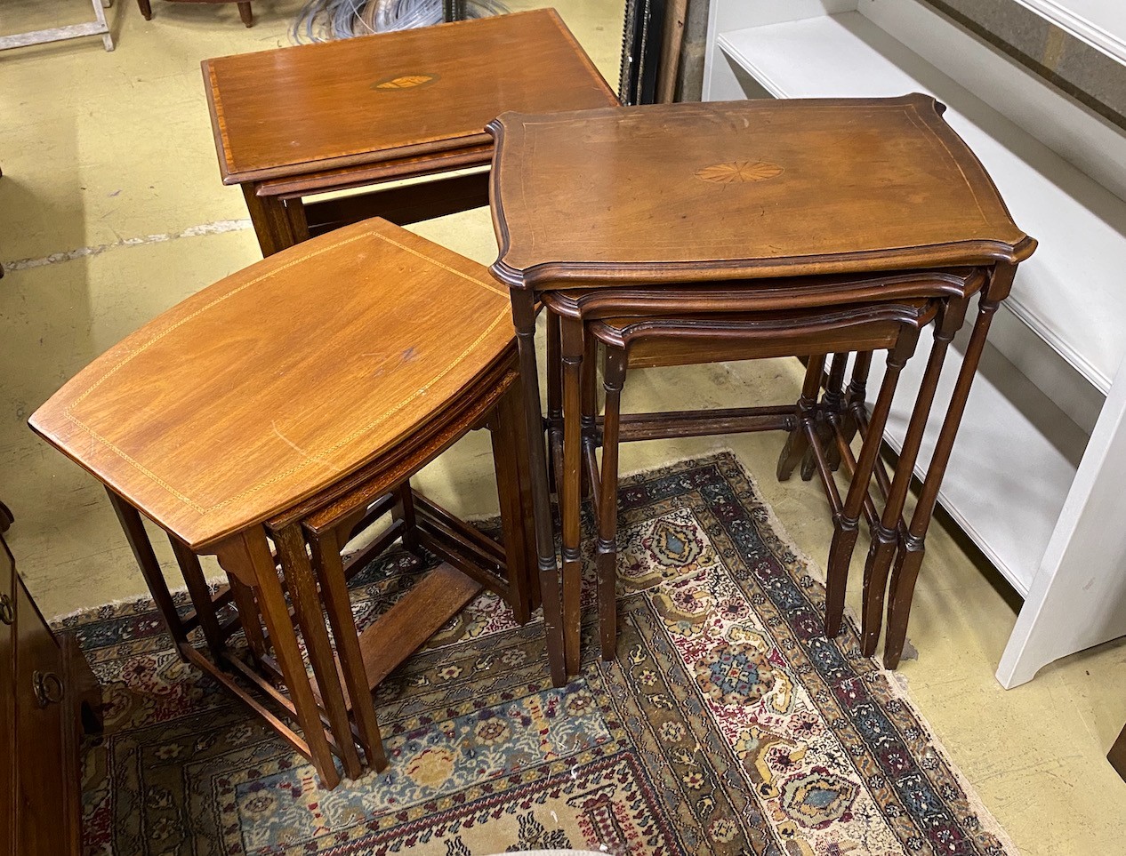 Three nests of Edwardian inlaid mahogany tea tables, largest width 56cm, depth 38cm, height 57cm